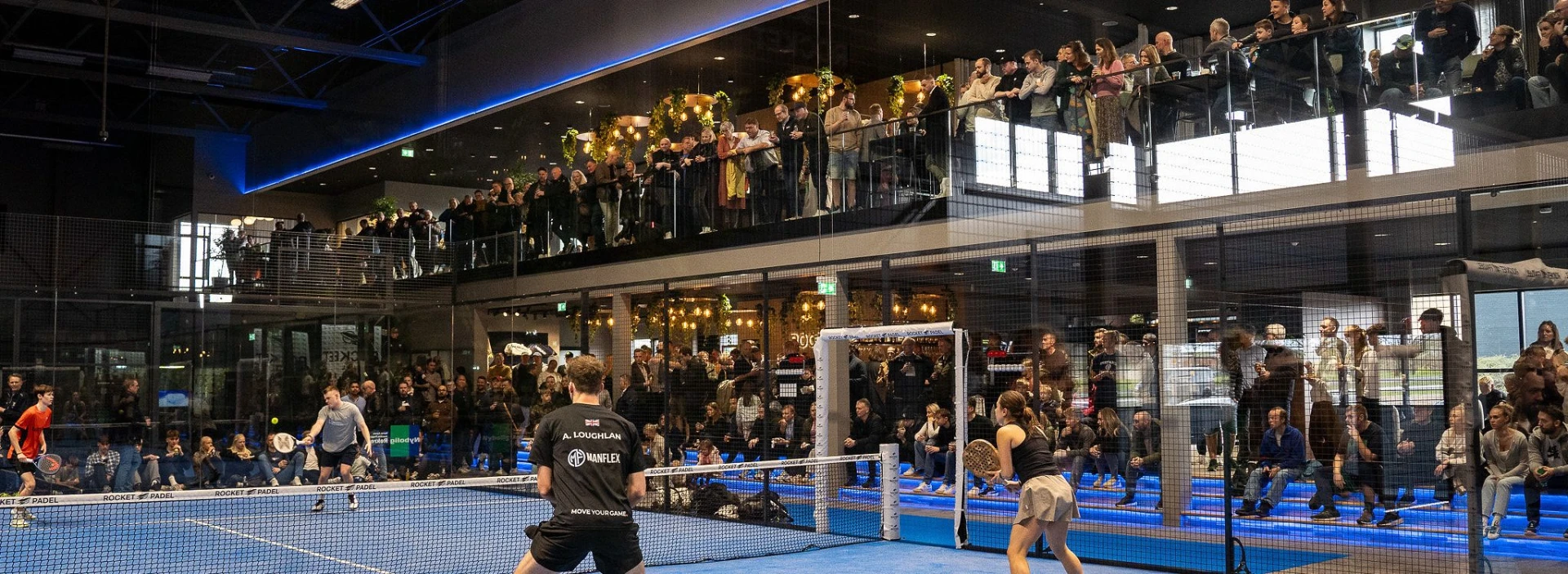 Players and spectators filling a Rocket Padel facility during an event